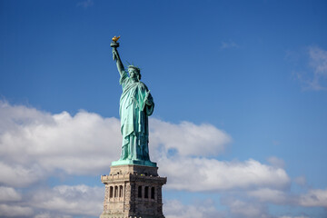 Fototapeta na wymiar The Statue of Liberty in New York against a blue sky