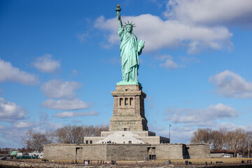 Fototapeta na wymiar The Statue of Liberty in New York against a blue sky