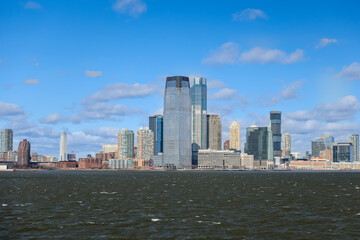 Fototapeta premium Views of Battery Park and the financial district from the water and Ellis Island in New York City