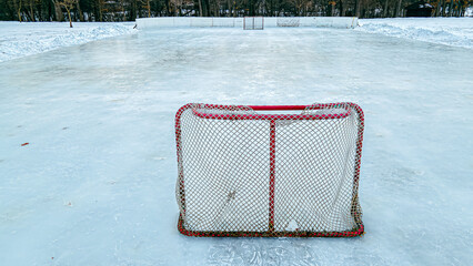 Red hockey net on outside ice rink