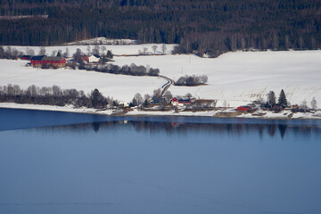 Farms by Lake Mjøsa in winter.
