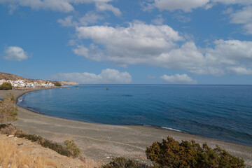 Summer landscape of Crete island in Greece in Europe. Coast in the Larapetra region. In the background is a sunny sky with clouds.