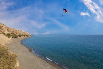 Summer landscape of Crete island in Greece in Europe. Coast in the Larapetra region. In the background is a sunny sky with clouds.