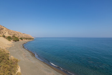Summer landscape of Crete island in Greece in Europe. Coast in the Larapetra region. In the background is a sunny sky with clouds.