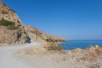 Summer landscape of Crete island in Greece in Europe. Coast in the Larapetra region. In the background is a sunny sky with clouds.