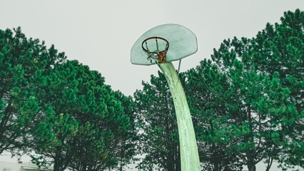 A long necked basketball hoop at a city park © Nealj121