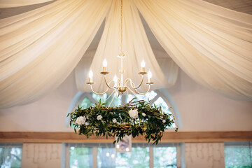 The original decorated chandelier in the restaurant at the wedding ceremony