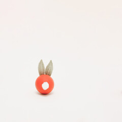 Easter bunny made of red painted egg, leaves and pom-pom. Minimal Easter concept. Copy space.