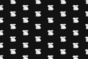 Easter seamless pattern with white bunny on black background.