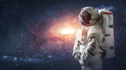 Surreal wallpaper with astronaut in space. Galaxy and stars. Spaceman sci-fi image. Elements of this image furnished by NASA