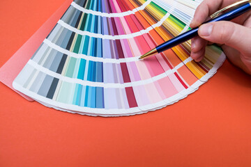 male hand choose color in palette samples