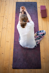 top view of woman doing yoga at home Janushiirasana