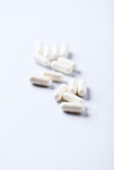Melatonin Capsules. Concept for a healthy dietary supplementation. Bright paper background. Soft...