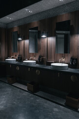 Contemporary interior of public toilet with walnut wall finishes and elegant glass partitions
