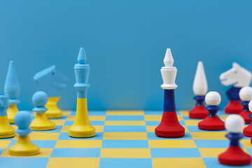 Ukrainian and Russian national colors chess sets on board
