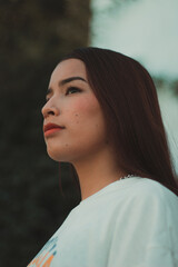 Cute red-haired girl with oriental features on a terrace