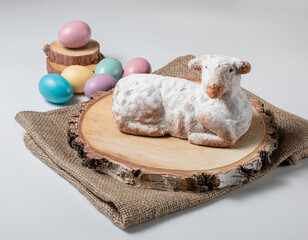 Easter sweet lamb cake, eggs, wood and sack on white background, stock photo
