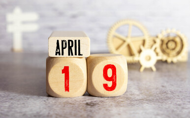 April 19 - from wooden blocks with letters, important date concept, white background random letters around