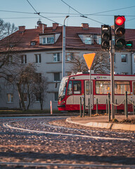 A tram going through the streets of Nowy Port in Gdańsk on a sunny morning. - obrazy, fototapety, plakaty