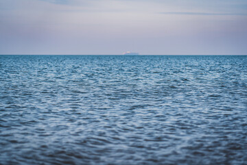 A calm sea surface on a cloudy day.