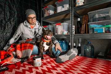 Person and french bulldog dog in emergency underground shelter - obrazy, fototapety, plakaty