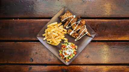 A plate of wings and fries.