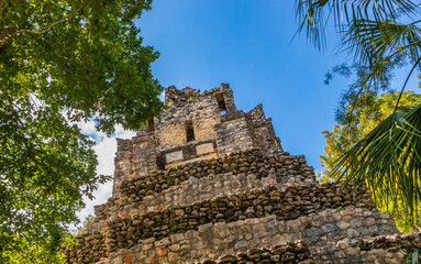 Fototapeta premium Ancient Mayan site with temple ruins pyramids artifacts Muyil Mexico.