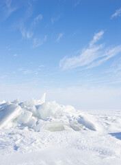 Fototapeta na wymiar Chunks of ice along winter lake in north