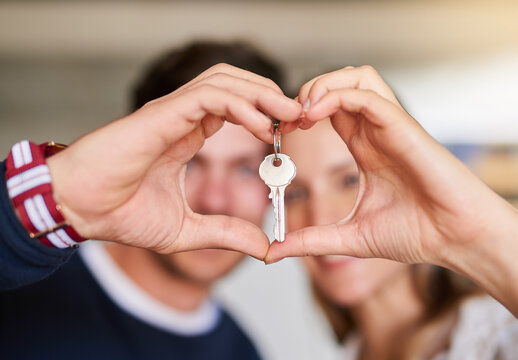 Love starts at home. Portrait of a happy young couple proudly displaying the keys to their new house.