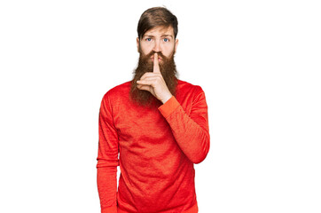 Redhead man with long beard wearing casual clothes asking to be quiet with finger on lips. silence and secret concept.