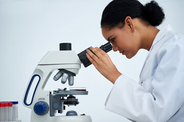 Sometimes the naked eye just isnt enough. Cropped shot of an attractive young female scientist...