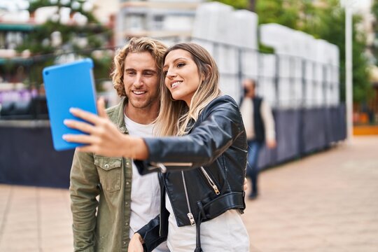 Man and woman couple smiling confident make selfie by the touchpad at park