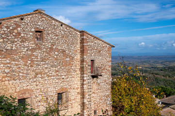 Fototapeta na wymiar View on old roofs, hills and vineyards from old town Montepulciano, Tuscany, Italy