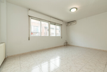 Empty living room with light glossy stoneware flooring, large aluminum window and air conditioner