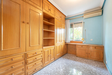 youth bedroom with custom wooden furniture with folding beds, drawers and shelves and blue painted walls