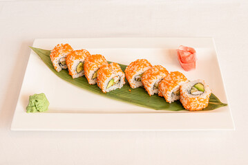 California roll uramaki sushi with masago roe stuffed with nori seaweed, avocado and surimi