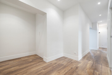 Entrance hall of a recently renovated house with wooden floors and fitted wardrobes