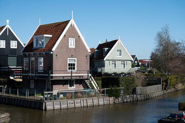 Walking on sunny day in small Dutch town Marken with wooden houses located on former island in North Holland, Netherlands