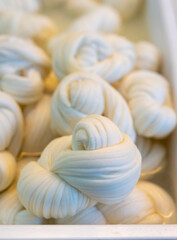 White soft braid cheese on market display
