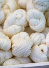 White soft braid cheese on market display