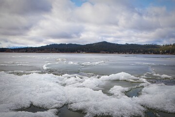 Snow clumps on a frozen lake.