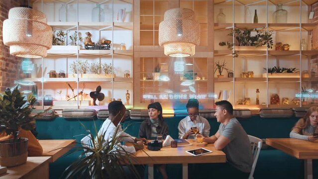 Concept of social network service. Friends chat while waiting the order. Futuristic cafe with augmented reality technology concept. Holographic projection with information.