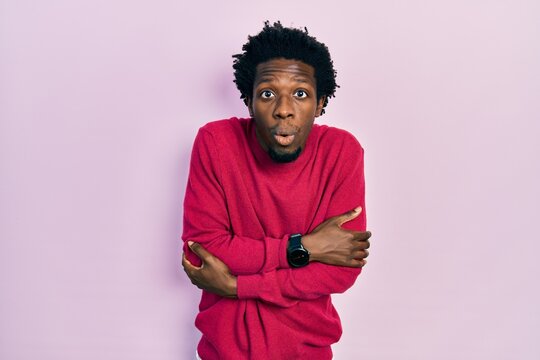 Young african american man wearing casual clothes shaking and freezing for winter cold with sad and shock expression on face