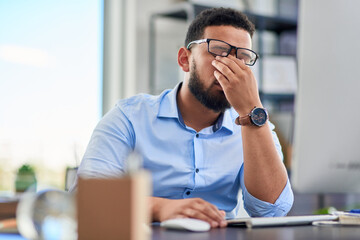 Obraz premium Not again. Cropped shot of a handsome young businessman sitting alone in his office and feeling stressed during the day.