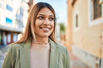 Young latin woman smiling confident at street