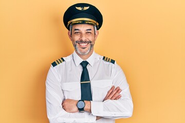 Handsome middle age man with grey hair wearing airplane pilot uniform happy face smiling with...
