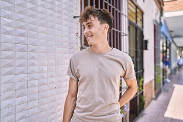 Young caucasian man smiling happy standing at the city.