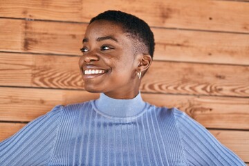 Young african american woman smiling happy standing at the city.