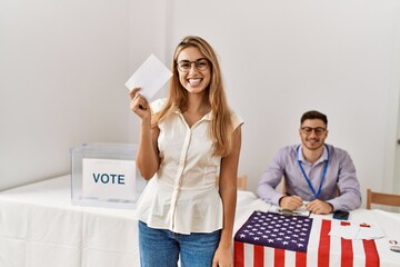 Young american voter woman smiling happy holding vote at electoral college.