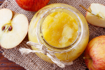 homemade apple sauce or apple puree in glass bowl over rustic wooden table